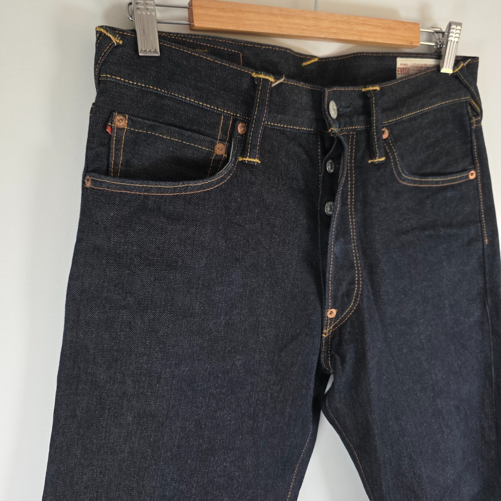 Evisu blue straight jeans with selvedge denim and button fly detailing.