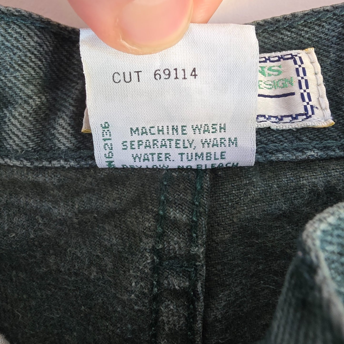 Levi's 501 white jeans distressed with natural wear, made in USA, classic fit.