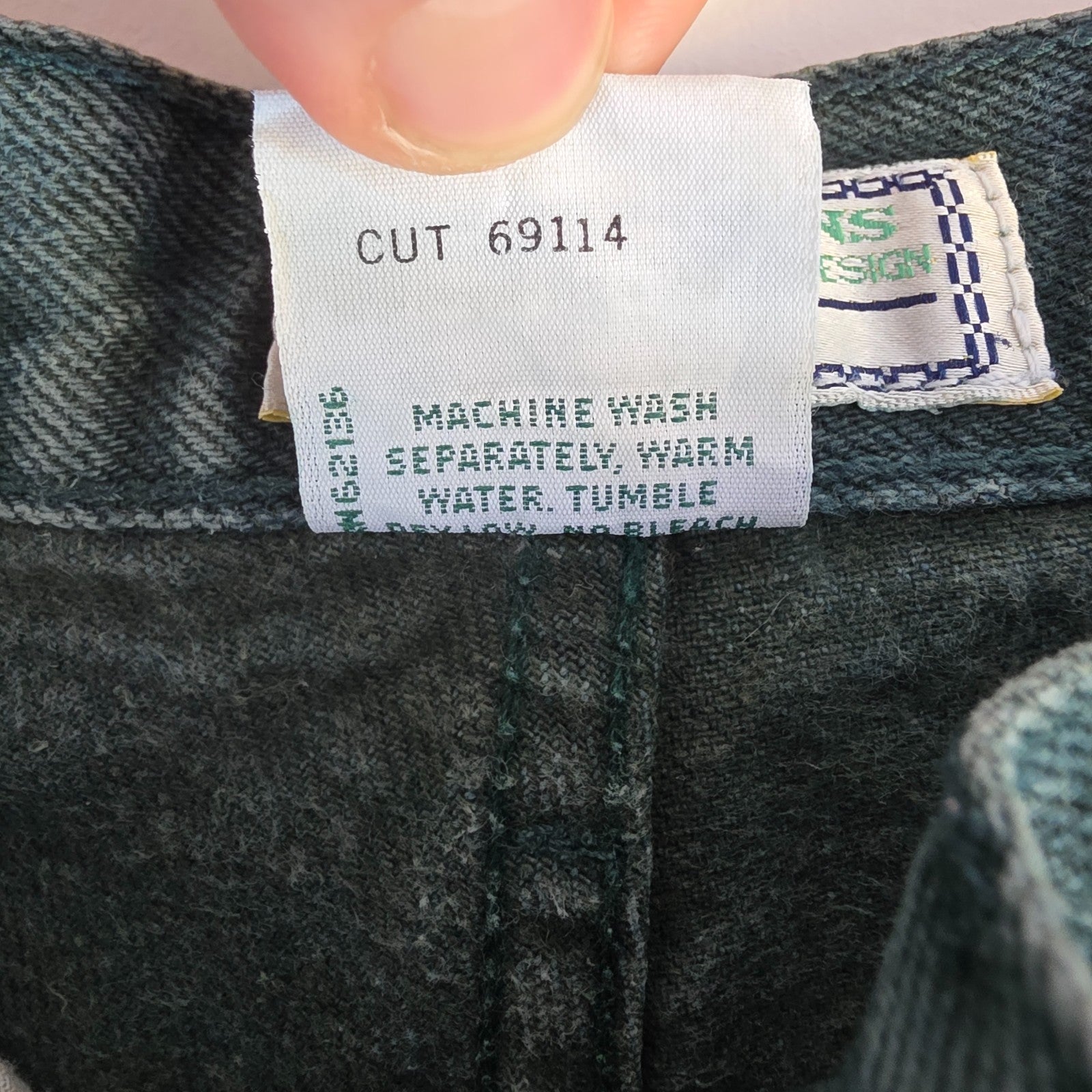 Levi's 501 white jeans distressed with natural wear, made in USA, classic fit.