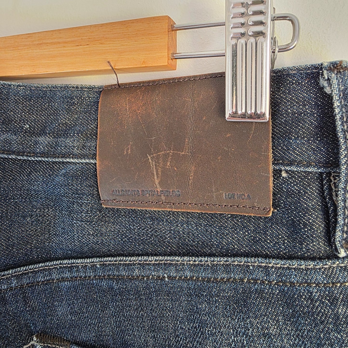 AllSaints blue straight jeans dark wash denim with subtle fading and slim fit.