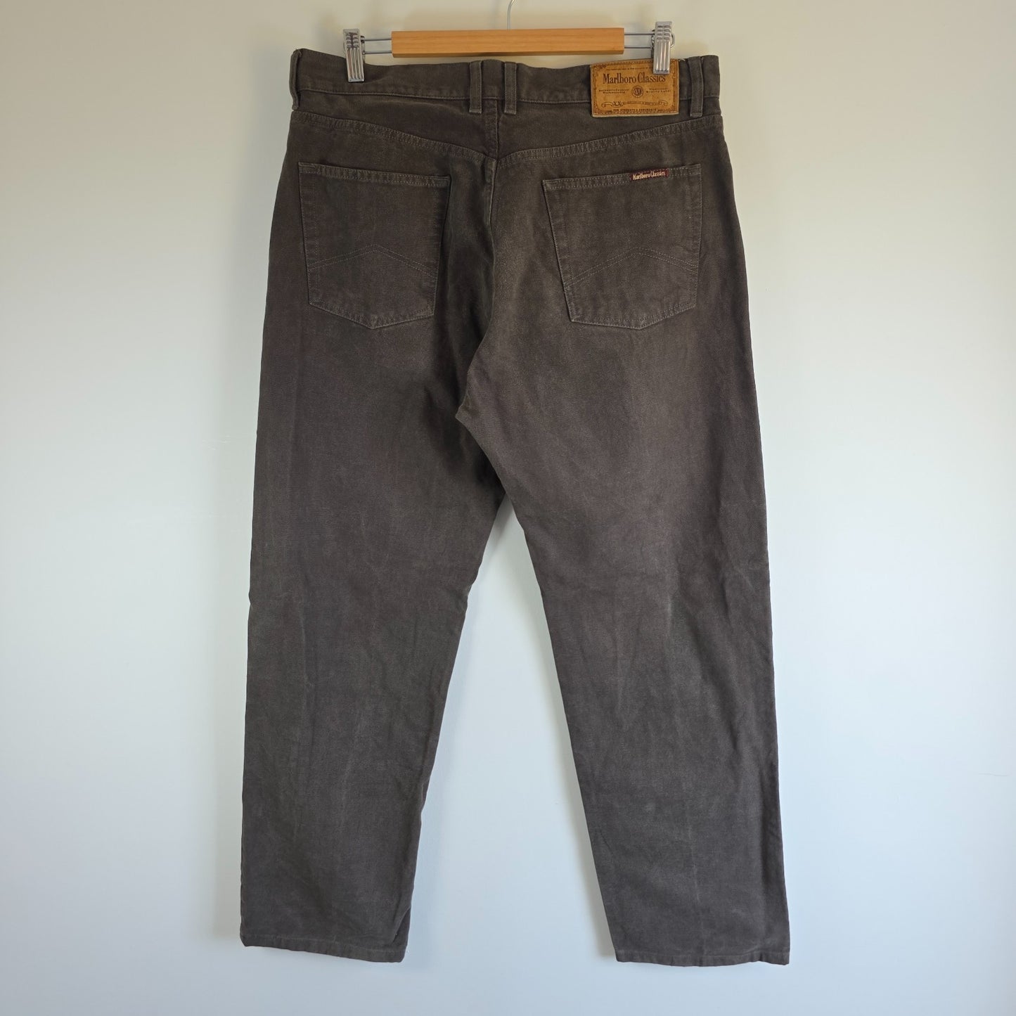 Marlboro Classics grey straight jeans with button fly and vintage logo detail.