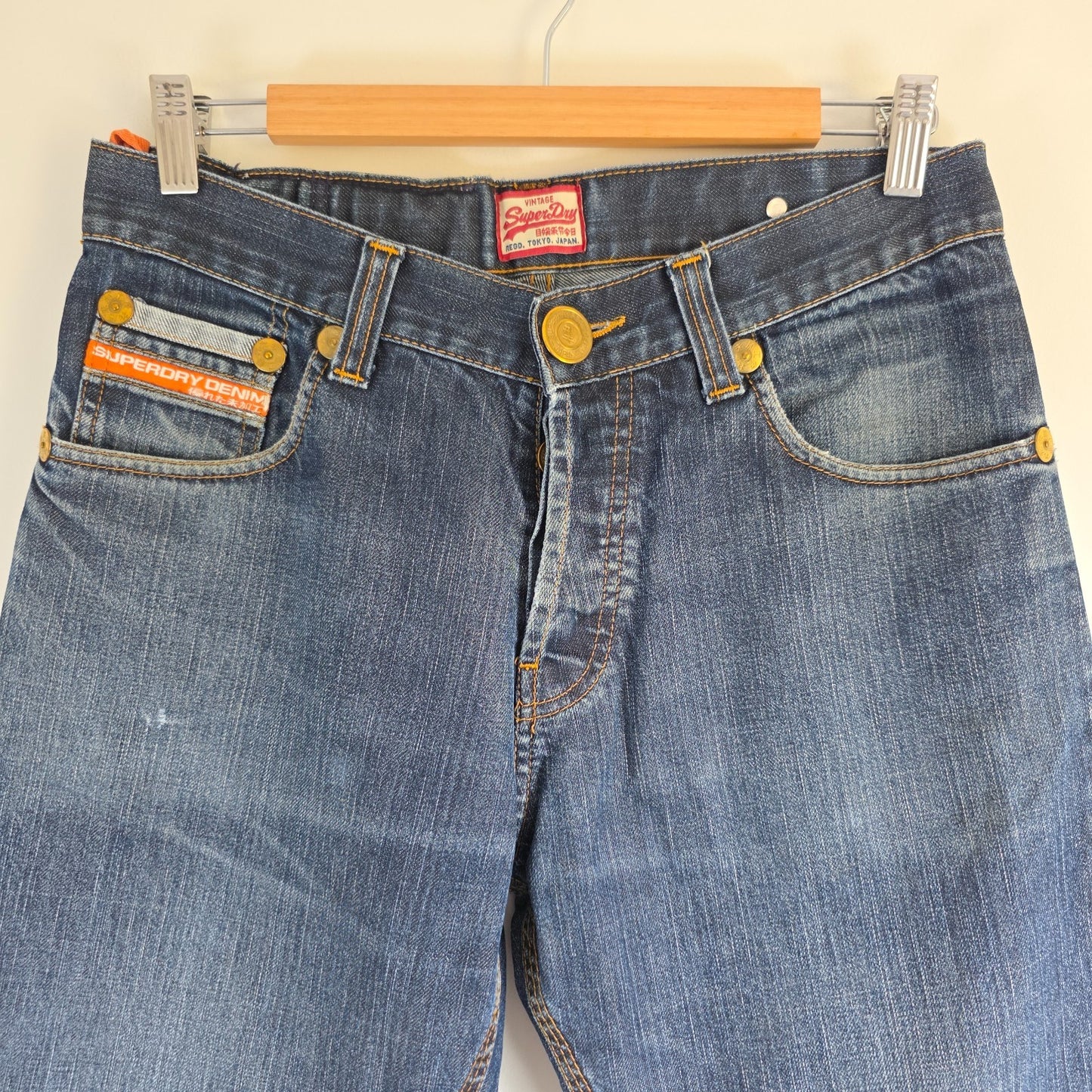 Superdry blue straight jeans with button fly, vintage raw denim, light wear.