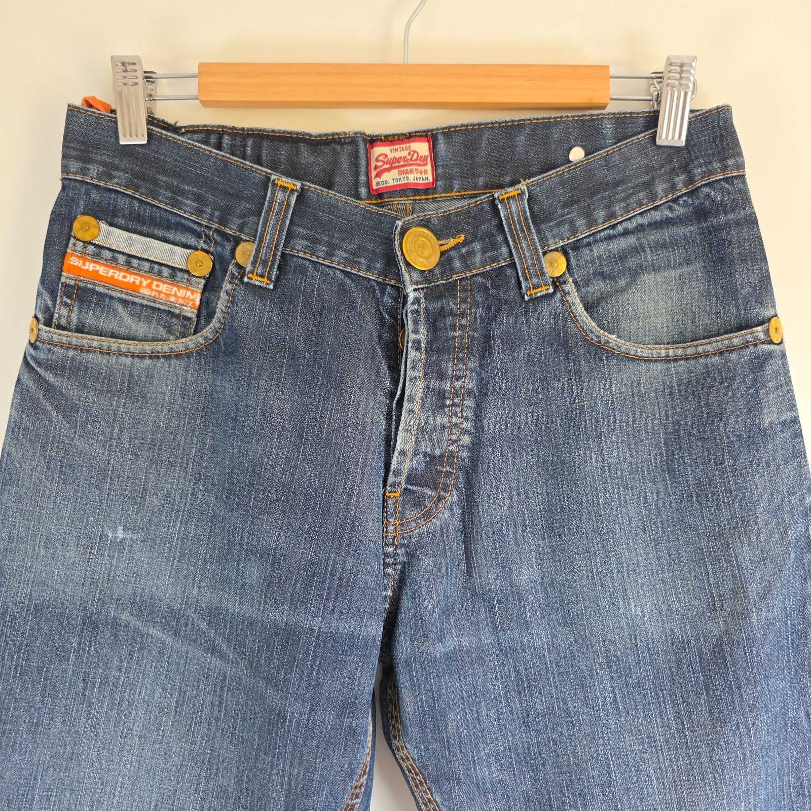 Superdry blue straight jeans with button fly, vintage raw denim, light wear.