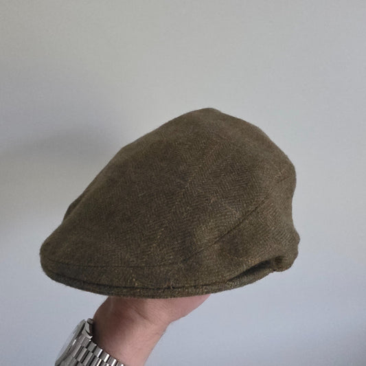 William Powell brown tweed flat cap with stitched panel construction and subtle flecks.