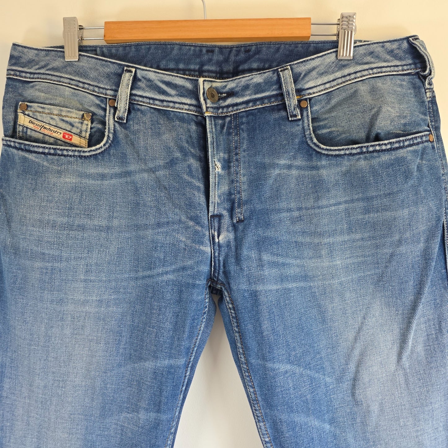Diesel blue bootcut jeans with button fly and vintage Zathan fit, 100% cotton.