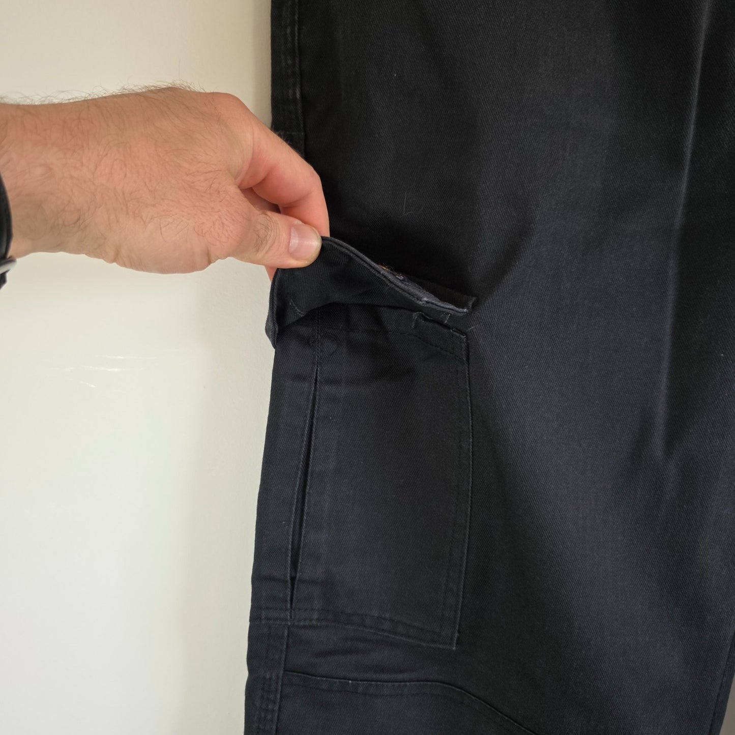 Dickies black cargo trousers with double knee panels and hammer loop detail.