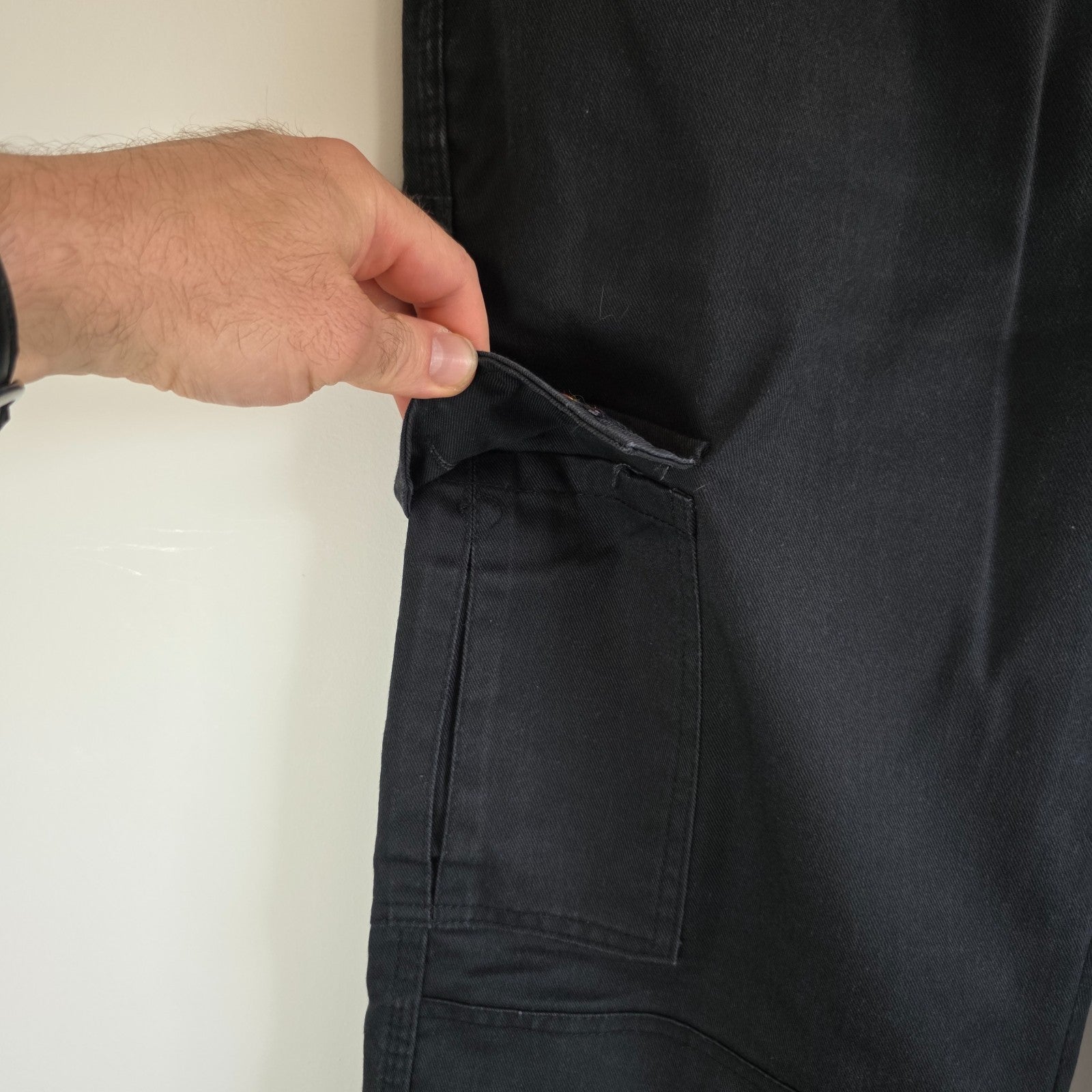 Dickies black cargo trousers with double knee panels and hammer loop detail.