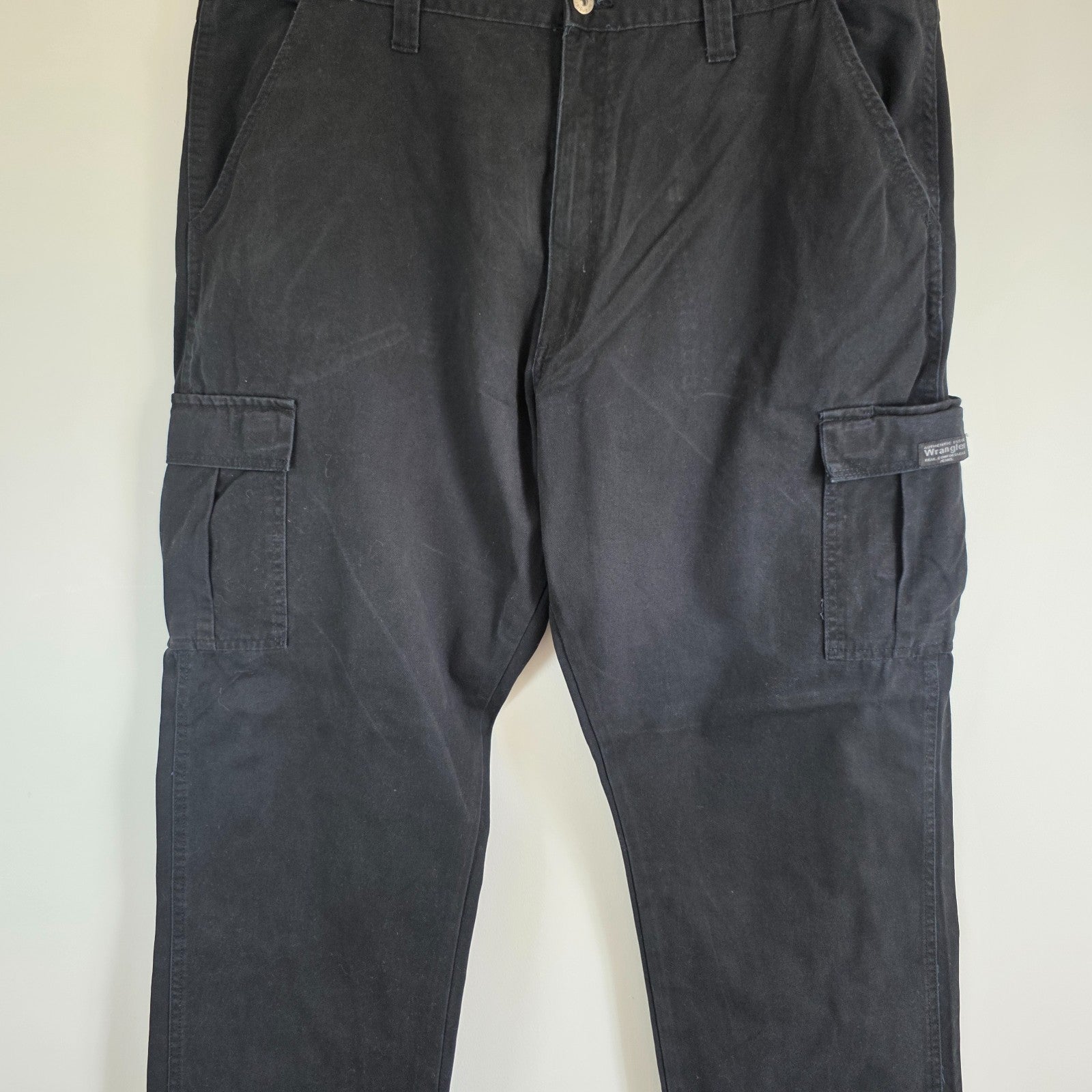 Wrangler black cargo trousers relaxed fit with utility pockets and durable cotton material.
