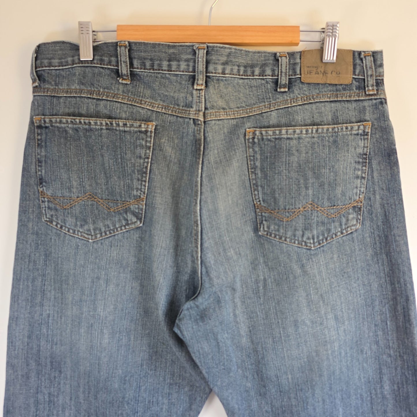 Wrangler blue straight jeans with relaxed fit, 100% cotton, professional hemmed to 30 inches.