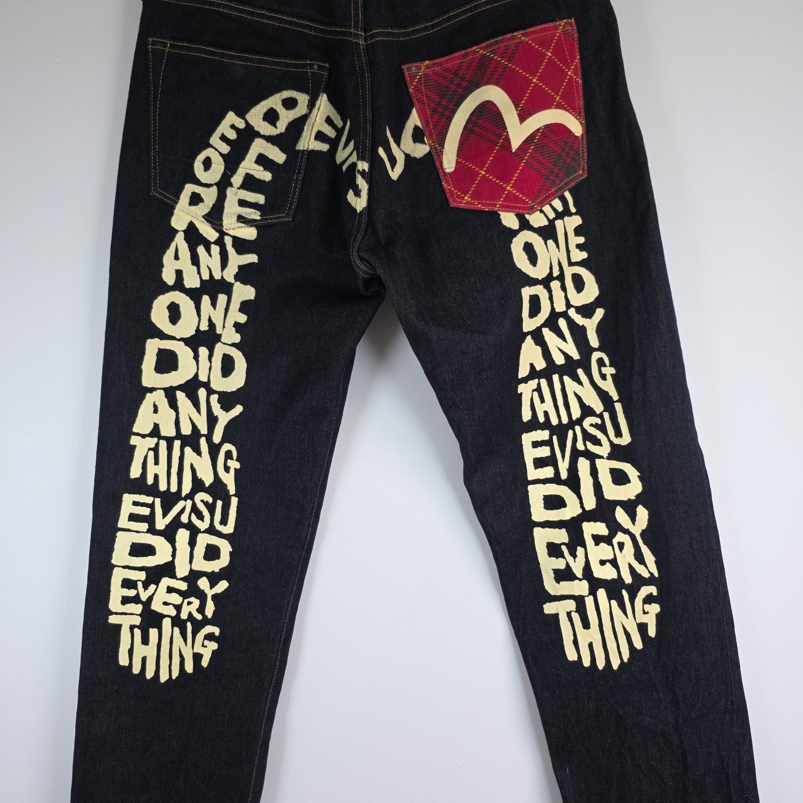 Evisu blue straight jeans with selvedge denim and button fly detailing.