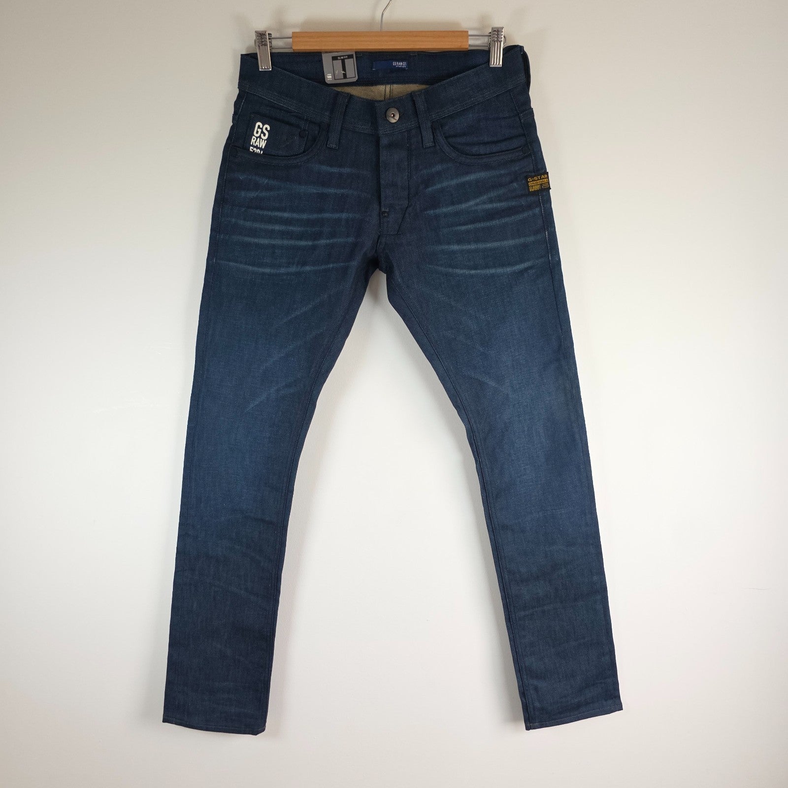 G-Star blue straight jeans with button fly and BNWT tag, cotton elastane blend.