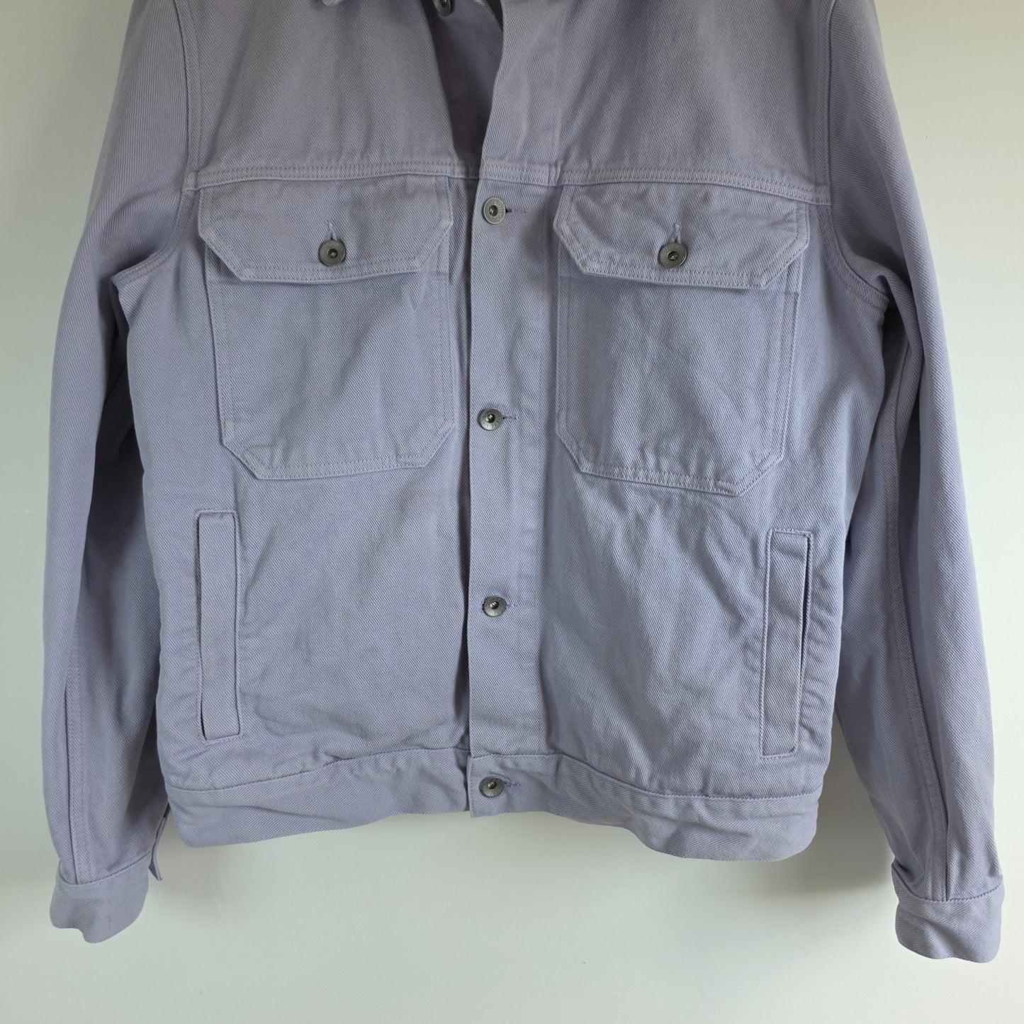 Albam lilac denim jacket with button front, chest pockets, and side pockets.