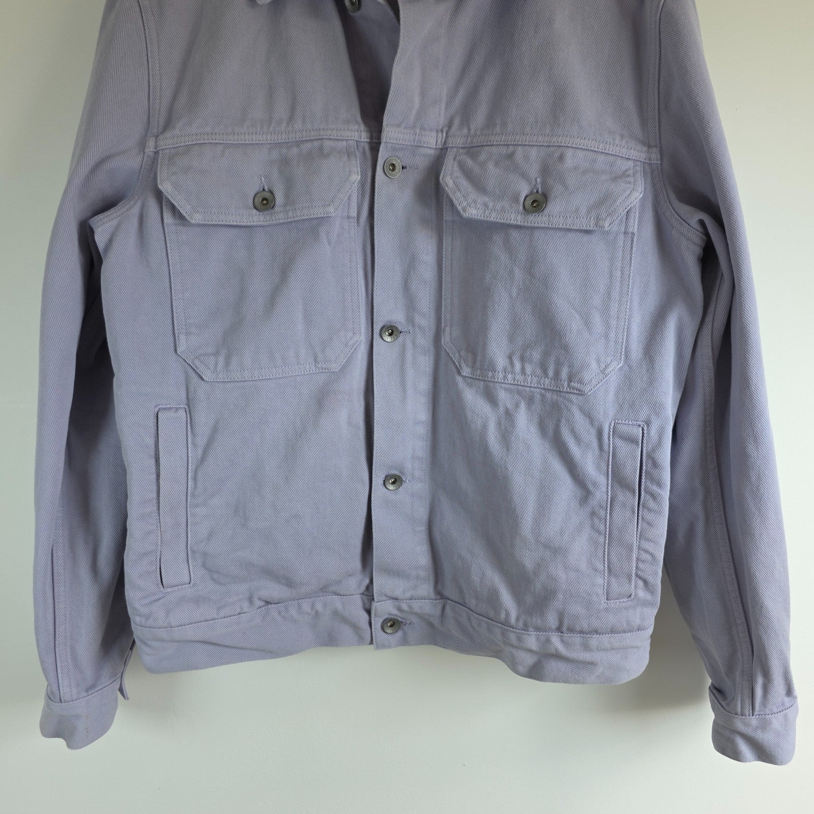 Albam lilac denim jacket with button front, chest pockets, and side pockets.