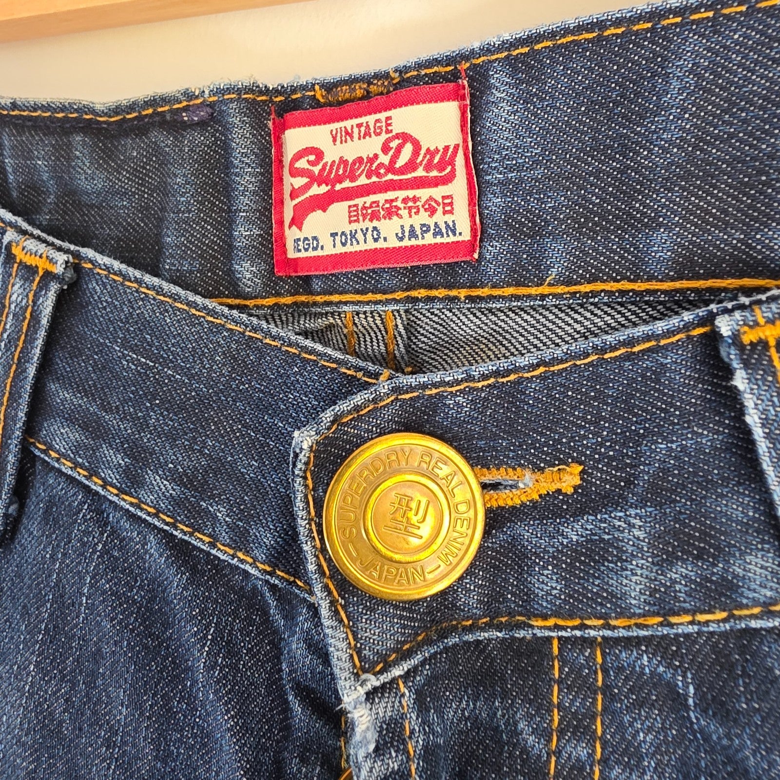 Superdry blue straight jeans with button fly, vintage raw denim, light wear.