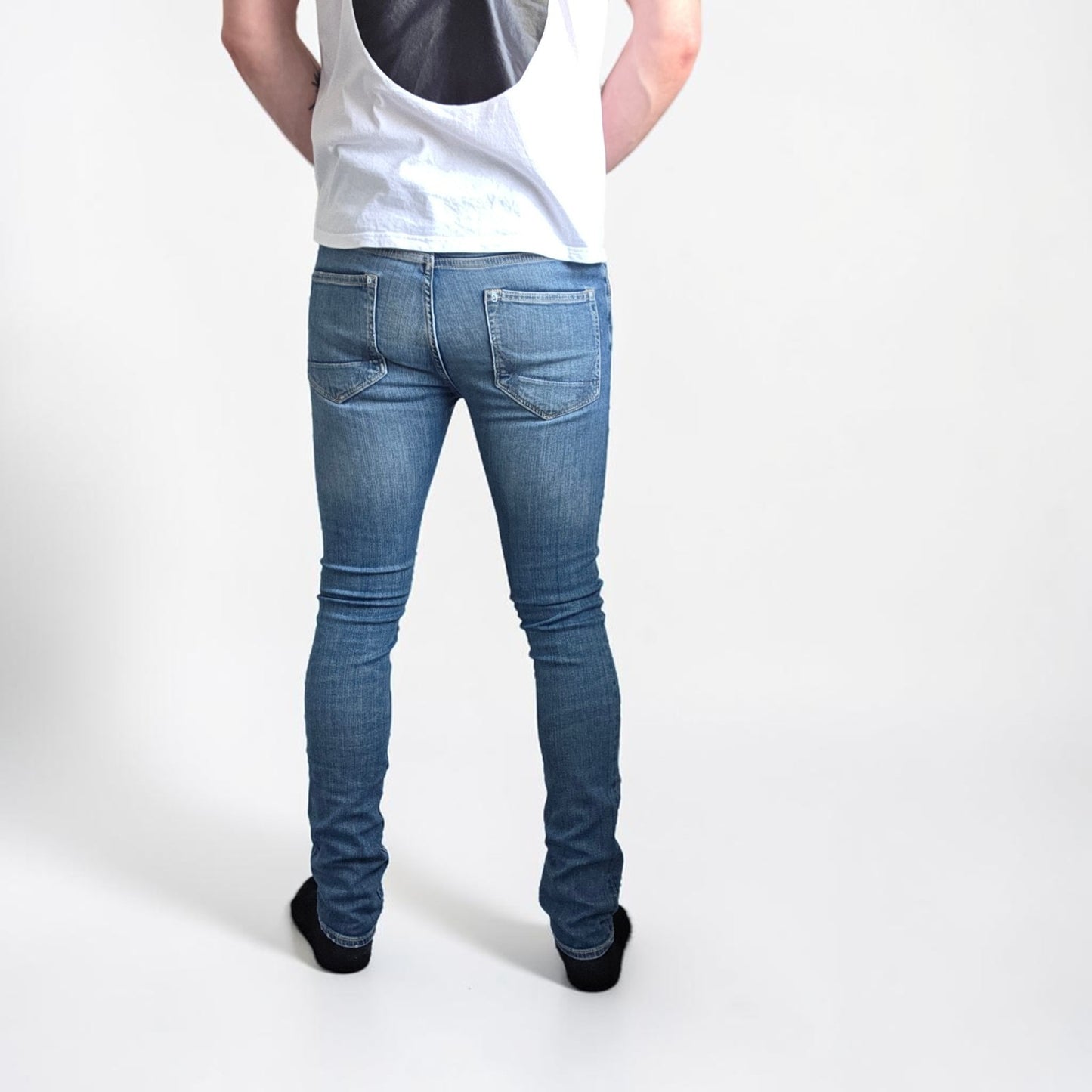 AllSaints blue skinny jeans with faded wash and modern slim fit design.