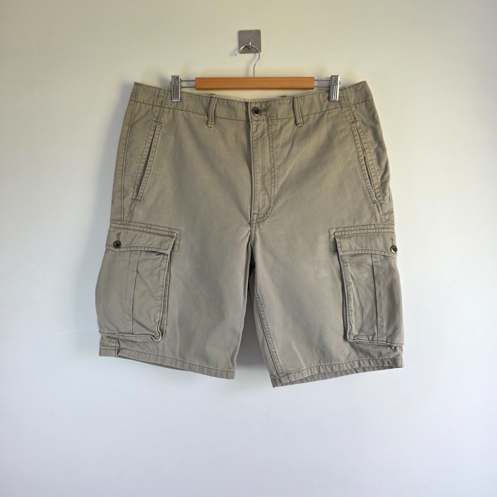 Levi's beige cargo shorts with utility pockets and cotton material, very good condition.