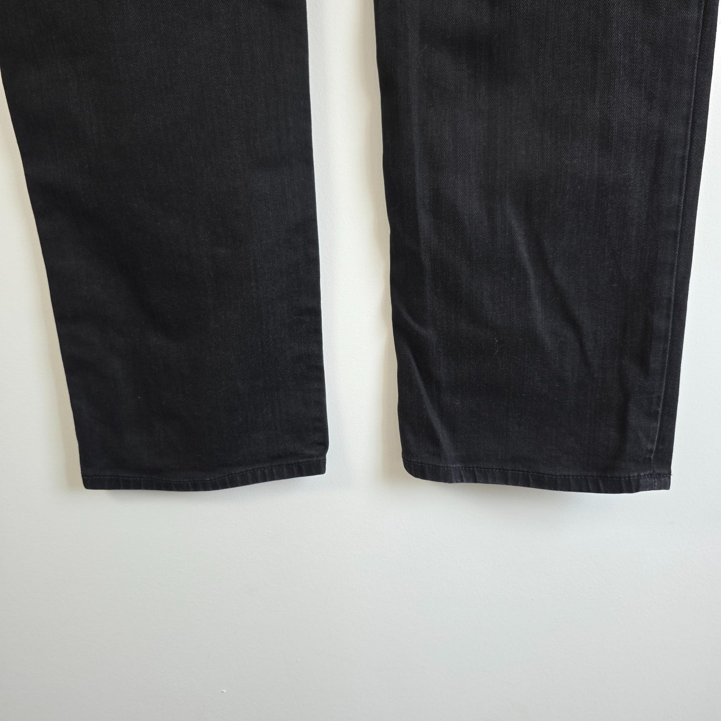 Calvin Klein black straight jeans with logo patch, stretch cotton blend, slim fit design.