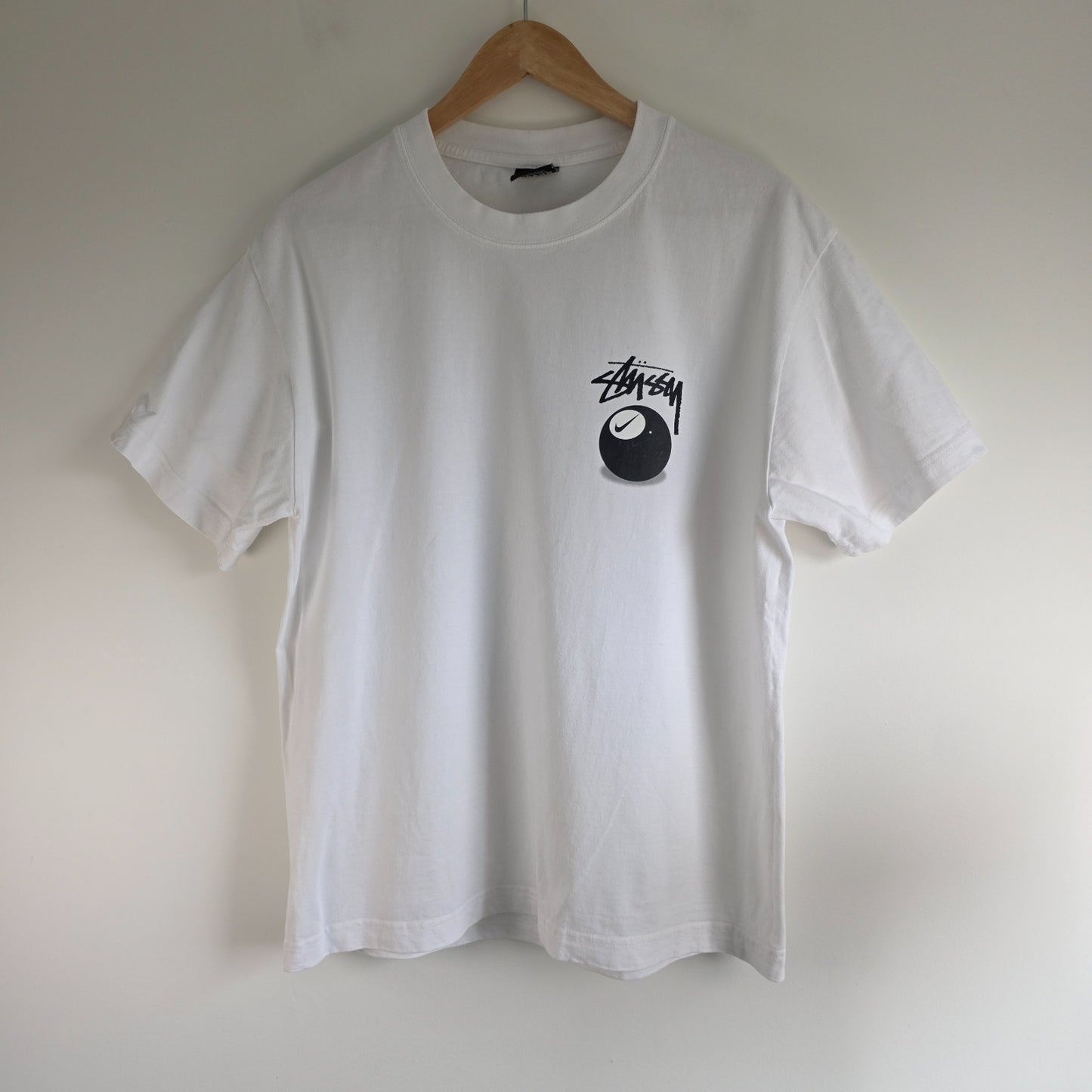 Stüssy x Nike white t-shirt with large 8 Ball back print and cotton material.