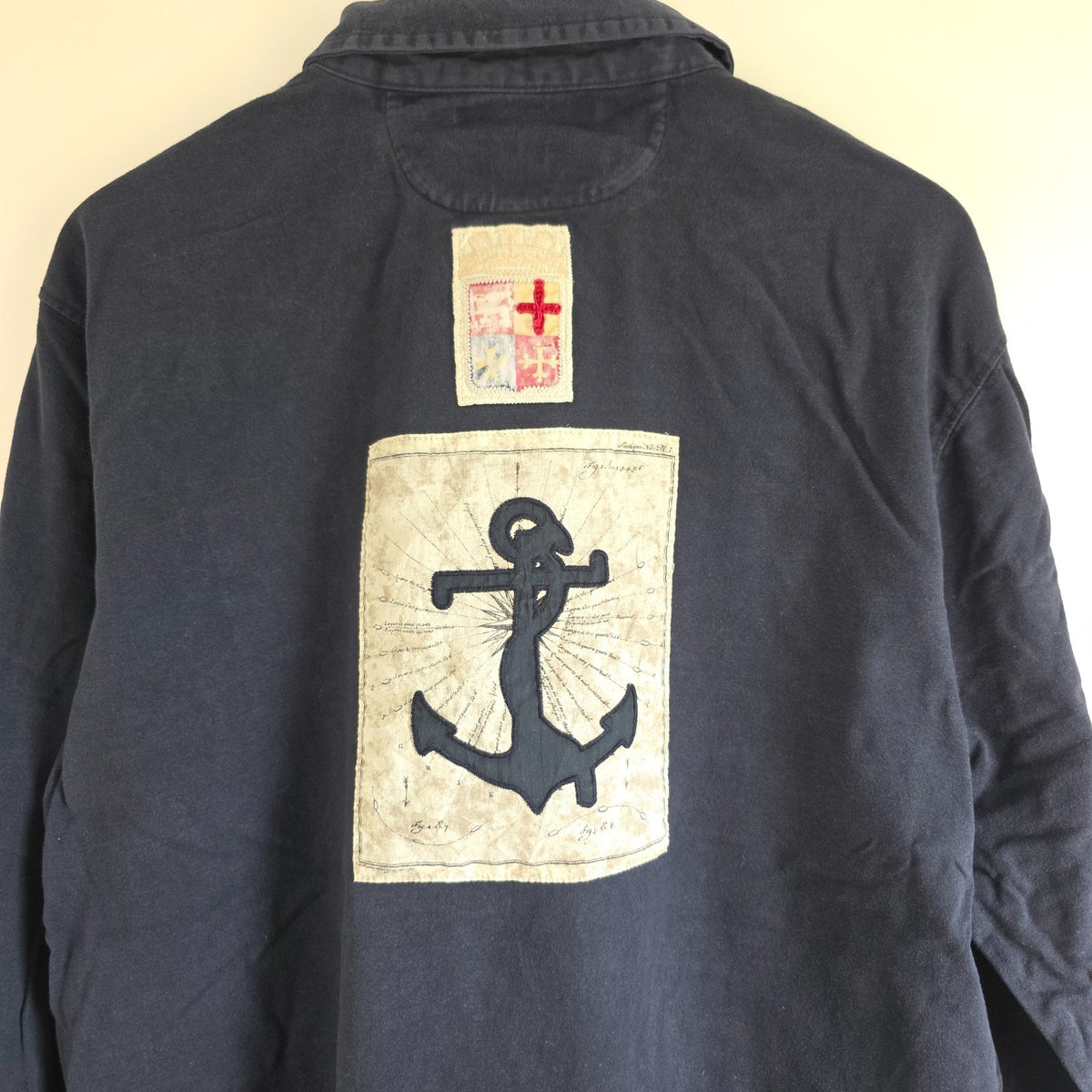 Marina Militare blue rugby shirt with embroidered crest and large nautical anchor appliqué.