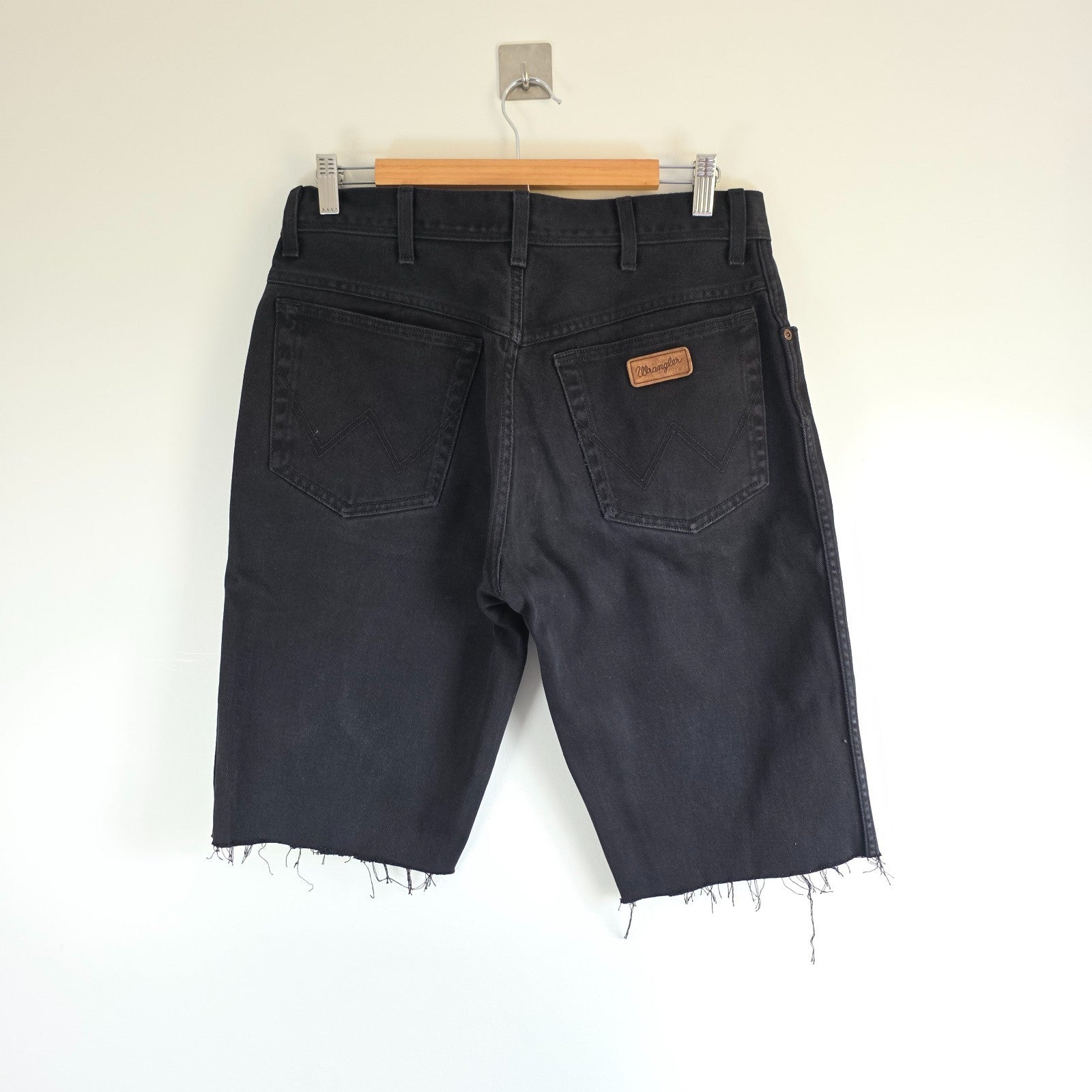 Wrangler black denim shorts W33 with frayed hems and copper-toned button.