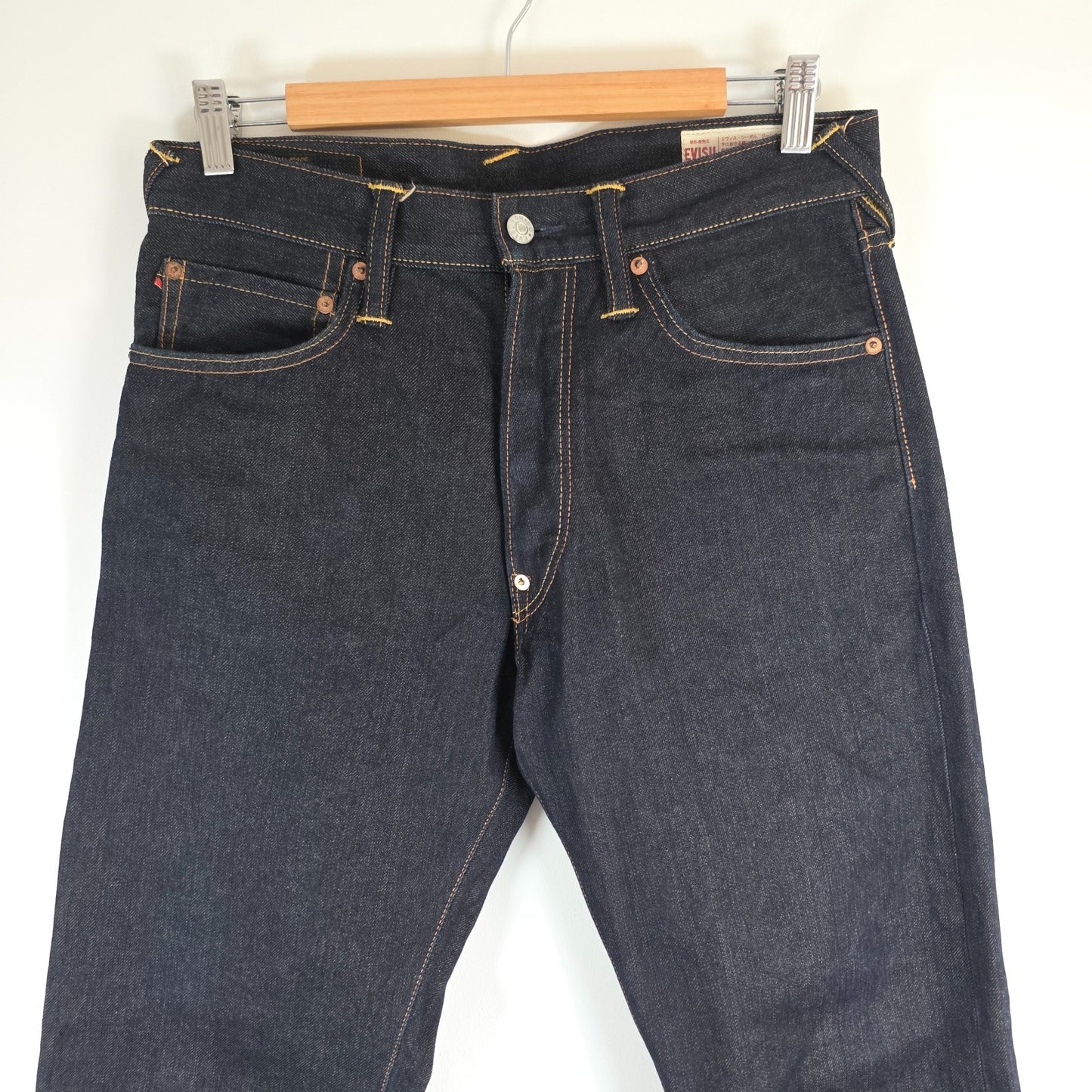 Evisu blue straight jeans with selvedge denim and button fly detailing.