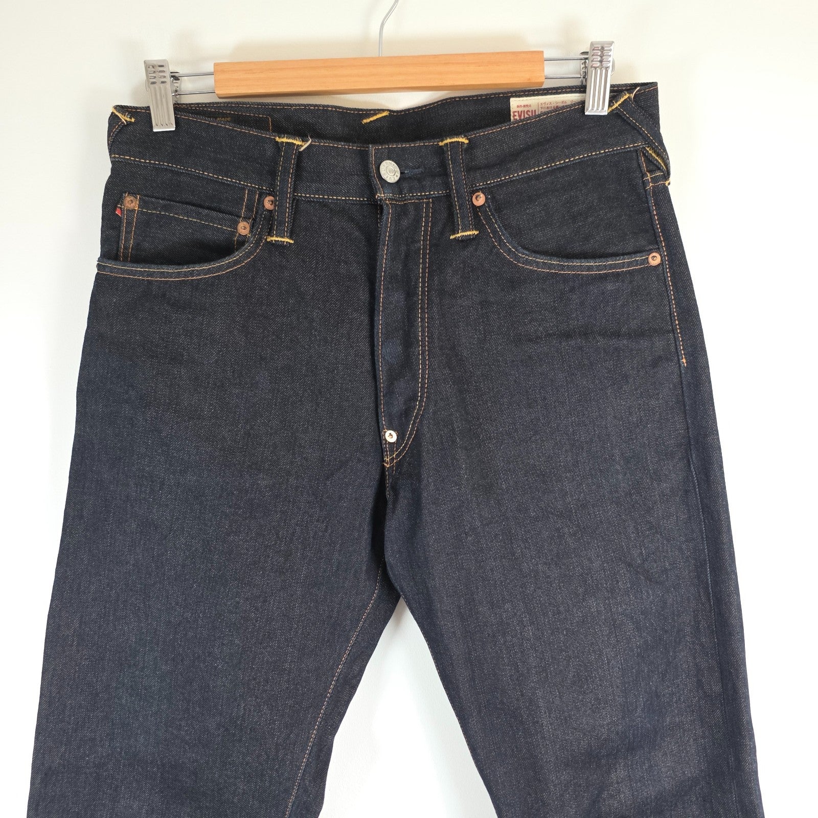 Evisu blue straight jeans with selvedge denim and button fly detailing.
