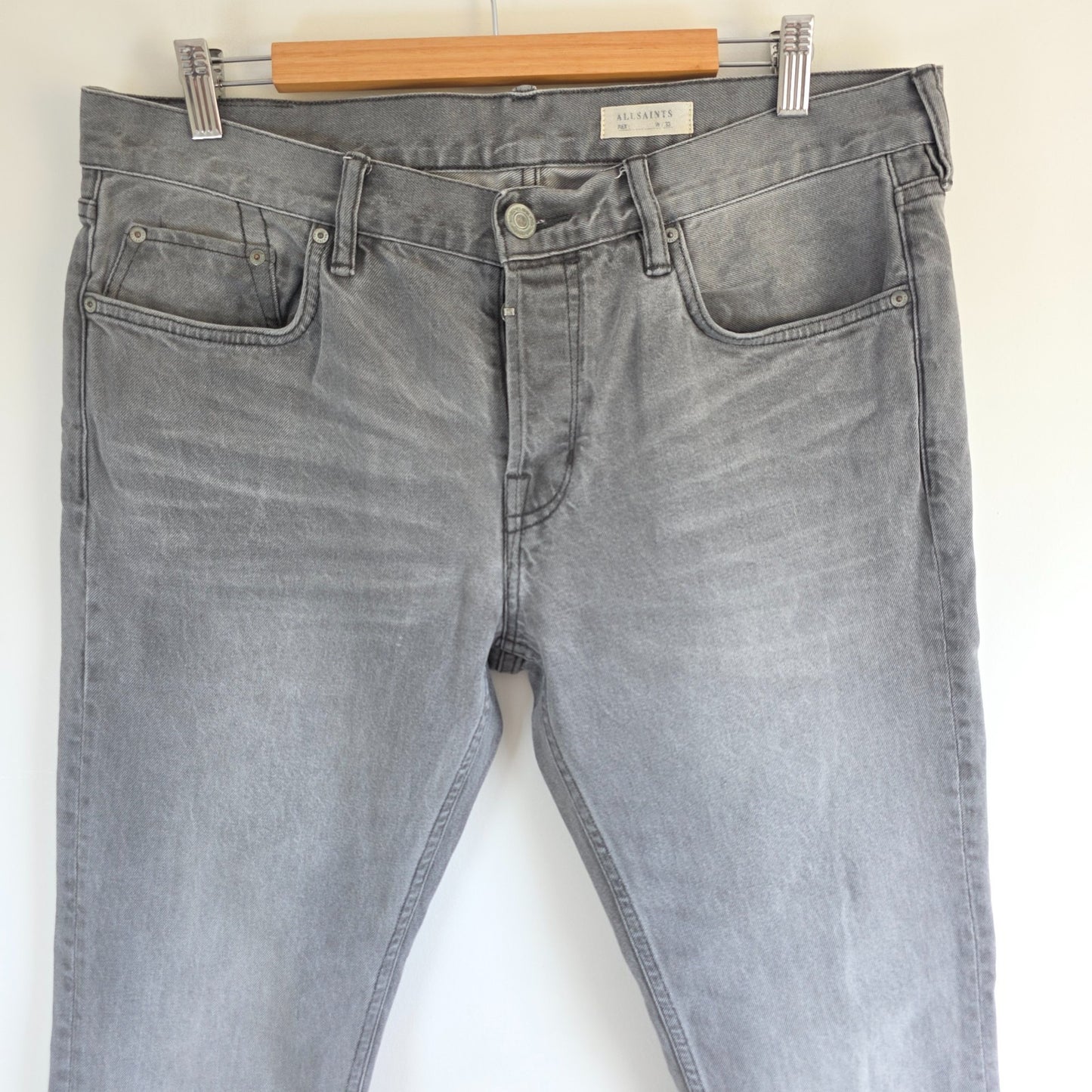 AllSaints grey slim jeans with button fly and stretch cotton elastane blend.