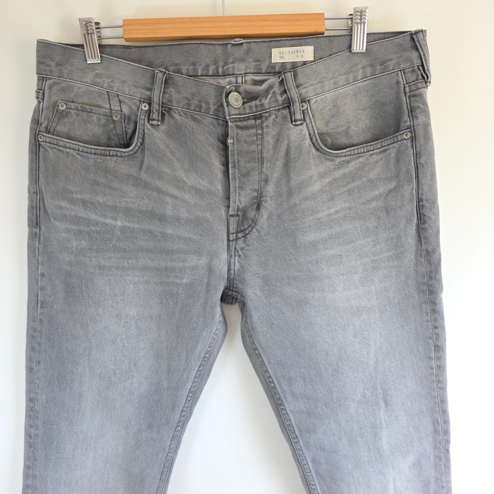 AllSaints grey slim jeans with button fly and stretch cotton elastane blend.