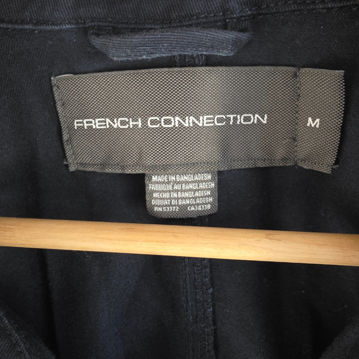 French Connection blue chore jacket with three patch pockets and metal button fastening.
