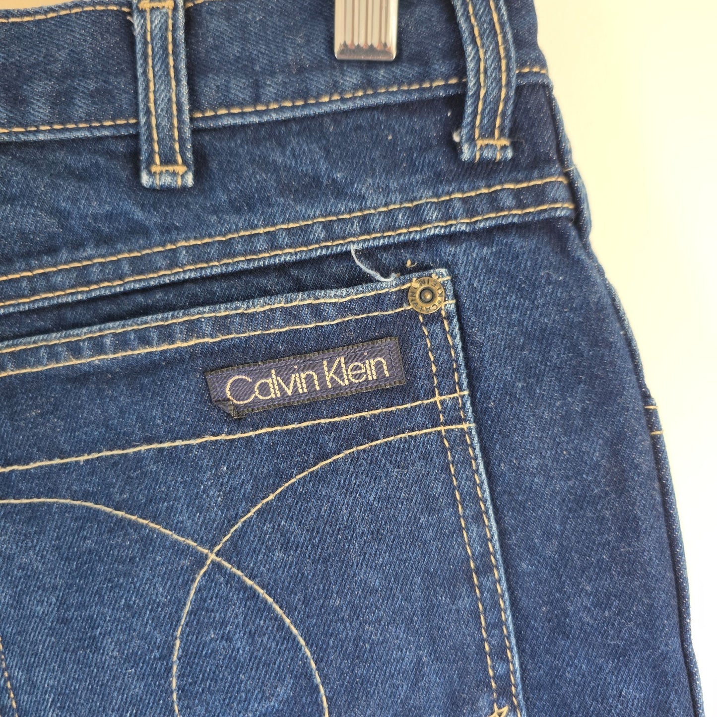Calvin Klein blue straight leg jeans with vintage 90s style and cotton material.