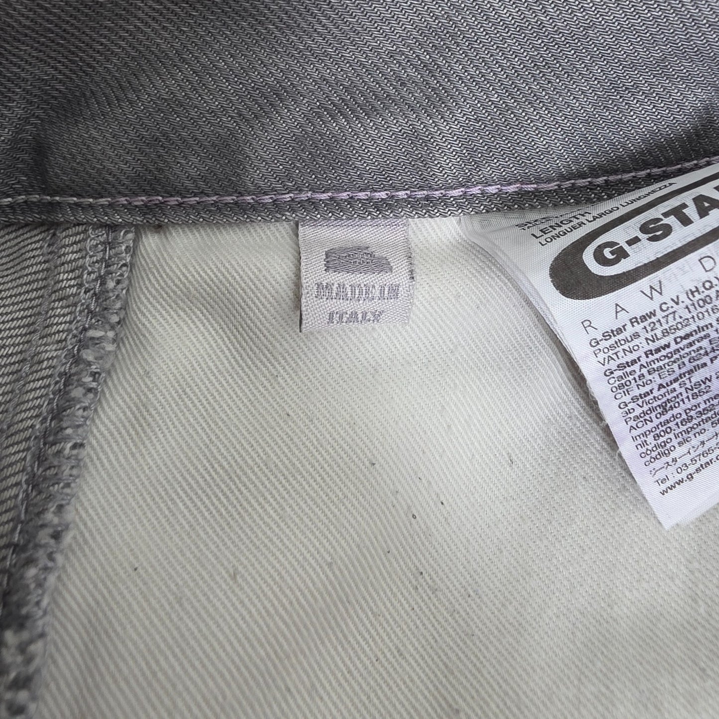 G-Star grey straight jeans with biker style detailing and subtle wear at the hem.