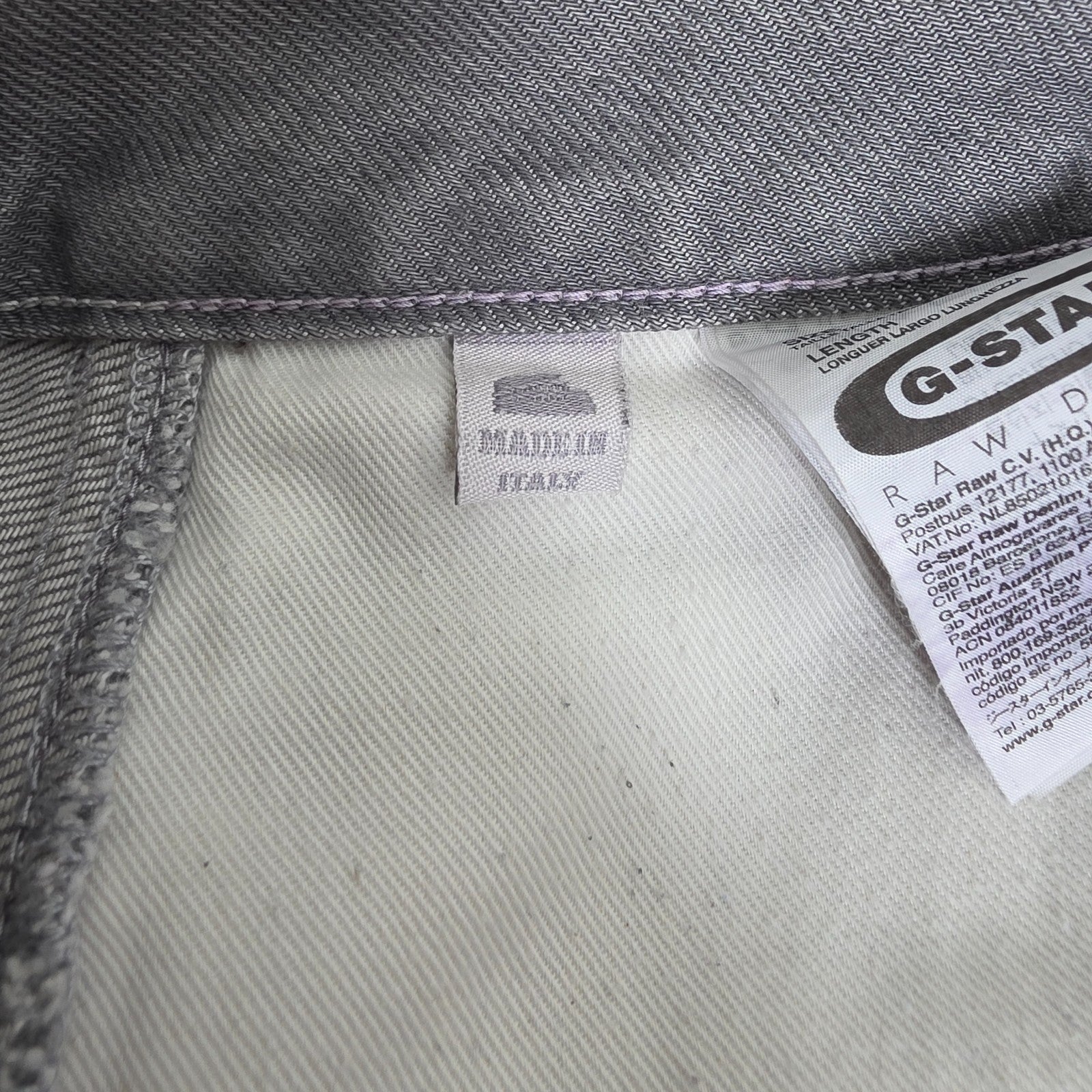 G-Star grey straight jeans with biker style detailing and subtle wear at the hem.