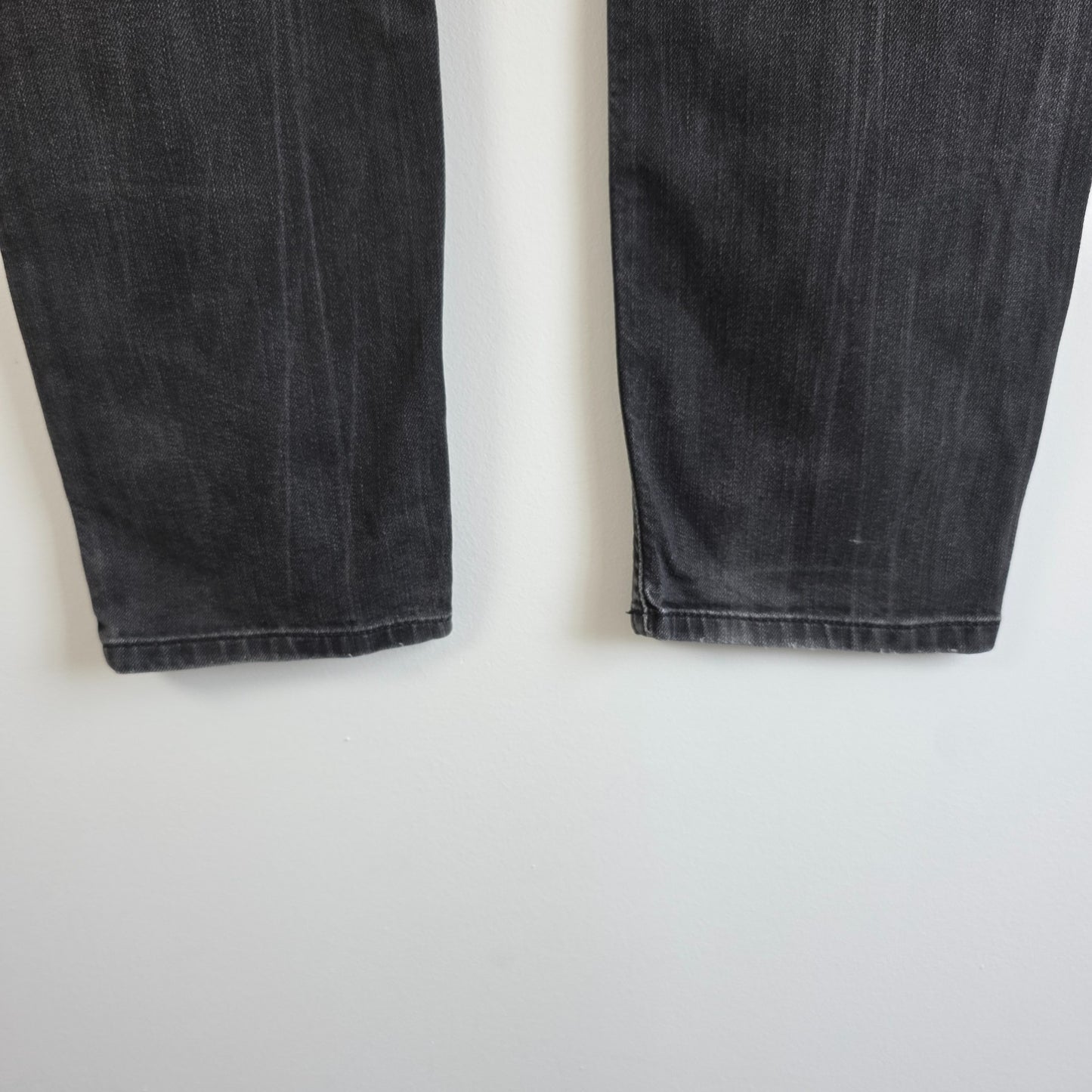 Diesel black straight jeans with grey wash, stretch denim, and branded tag.