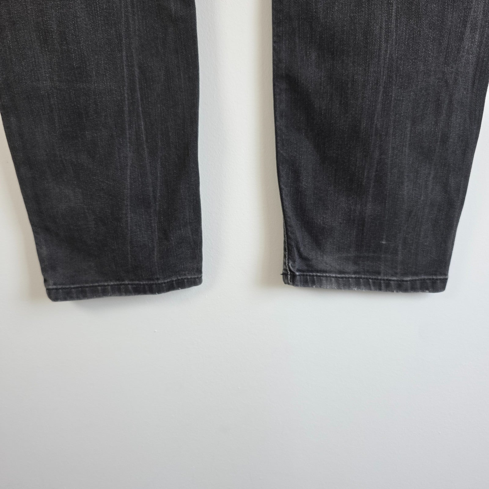 Diesel black straight jeans with grey wash, stretch denim, and branded tag.