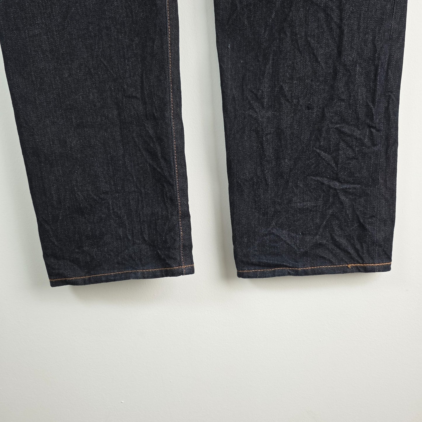 Evisu blue straight jeans with selvedge denim and button fly detailing.