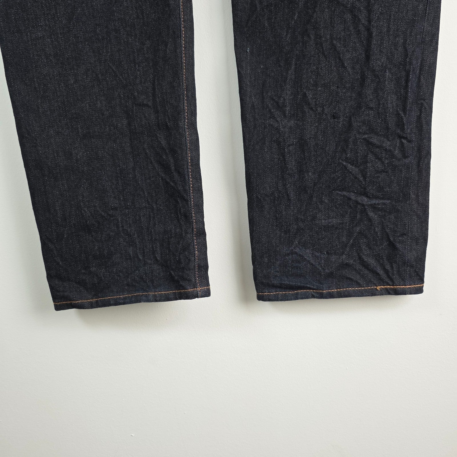 Evisu blue straight jeans with selvedge denim and button fly detailing.