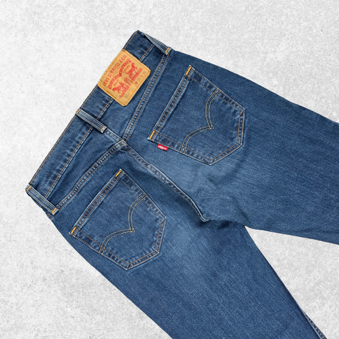 Levi's blue straight jeans with distressed patches and natural wear, made in USA.