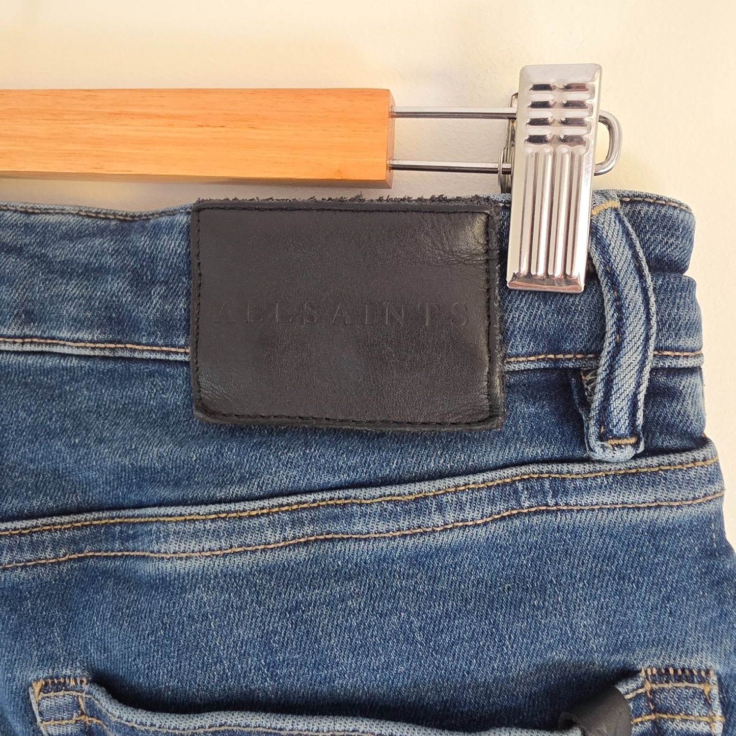 AllSaints blue straight jeans with button fly and stretch cotton-elastane blend.