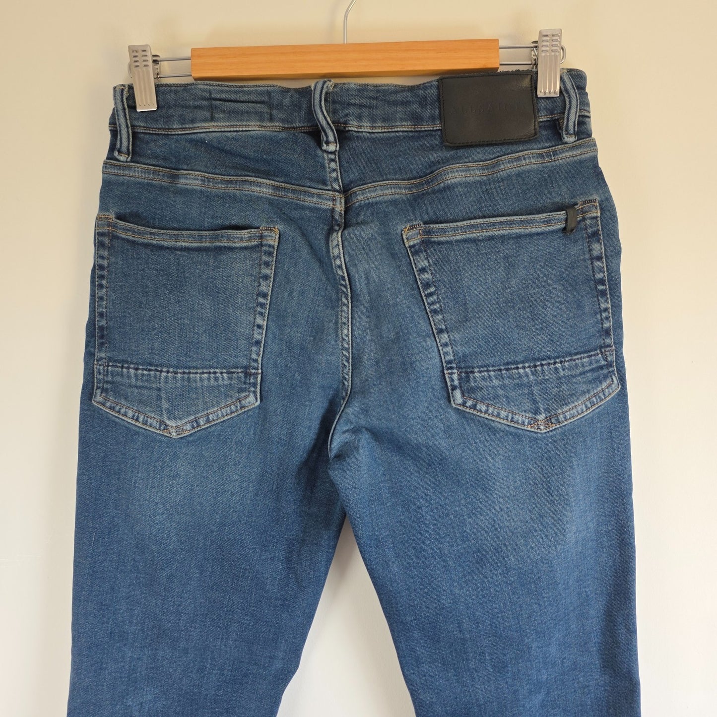 AllSaints blue straight jeans with button fly and stretch cotton-elastane blend.