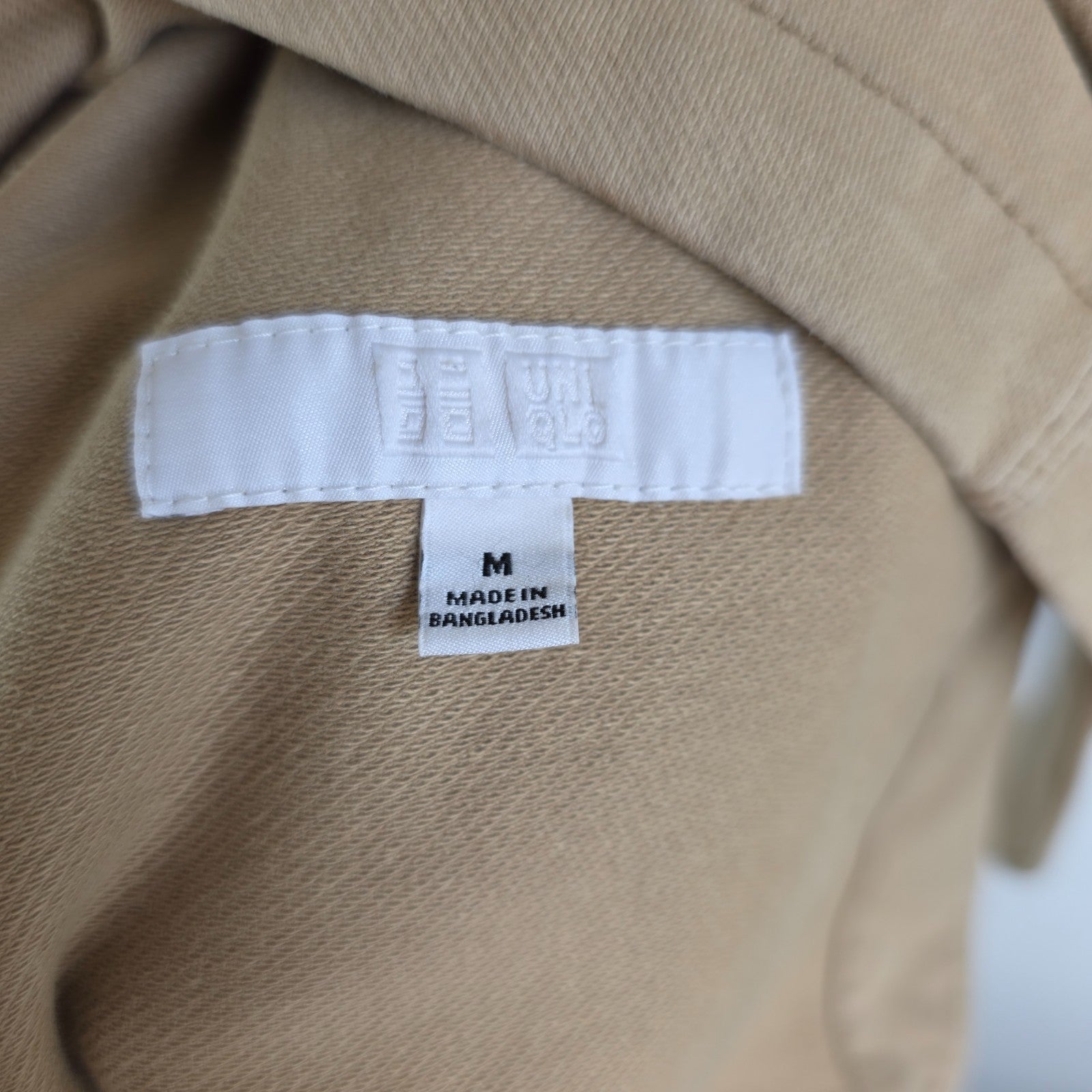 Uniqlo beige chore jacket medium cotton blend with subtle stretch and classic workwear design.
