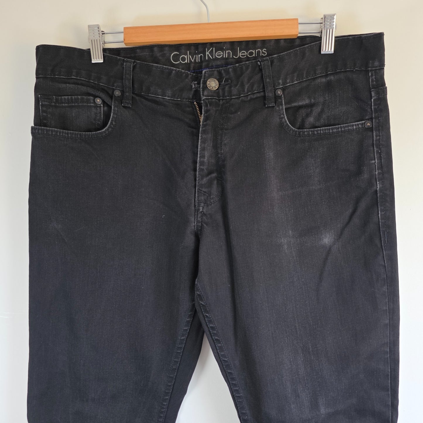 Calvin Klein black straight jeans with logo patch, stretch cotton blend, slim fit design.