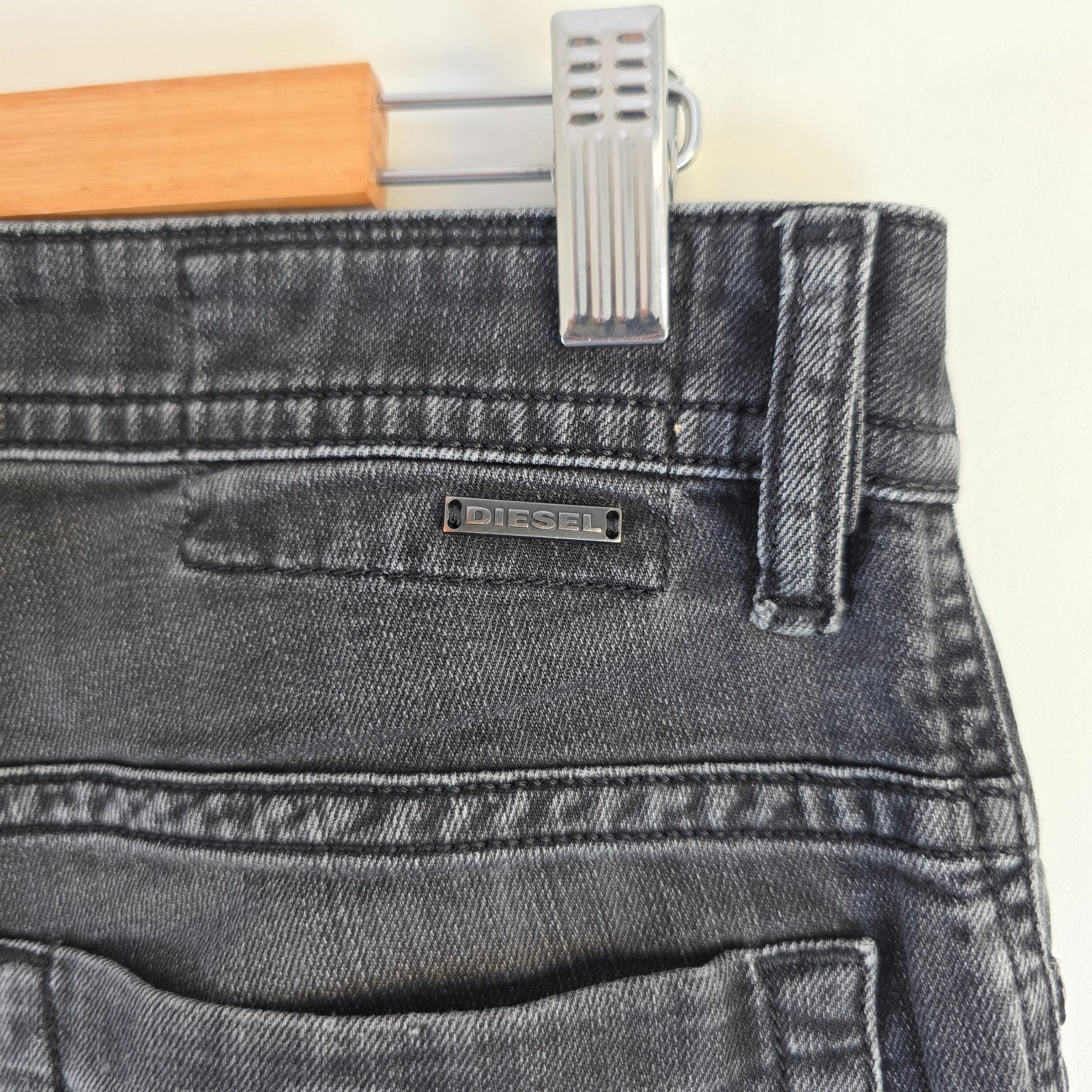Diesel black straight jeans with grey wash, stretch denim, and branded tag.