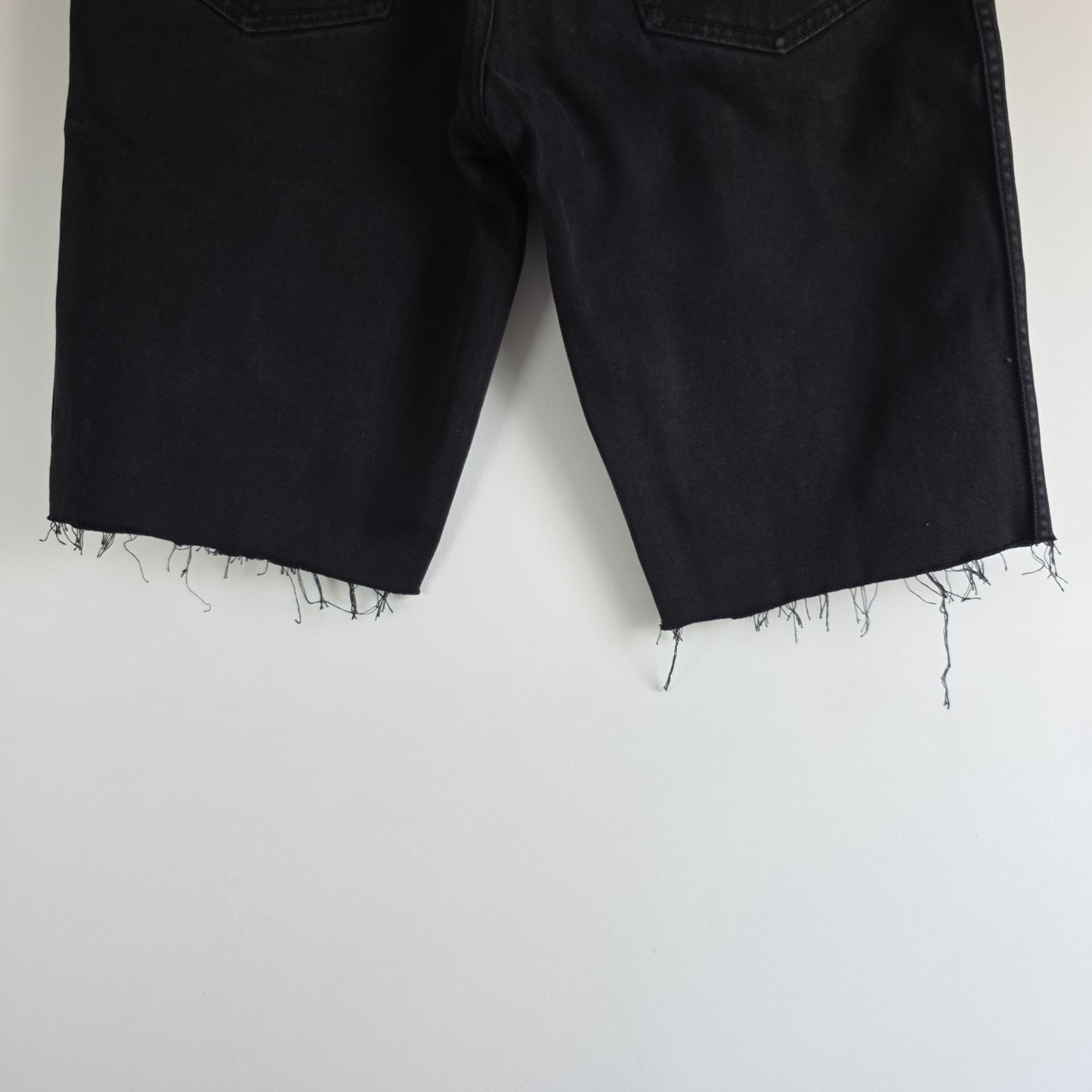 Wrangler black denim shorts W33 with frayed hems and copper-toned button.