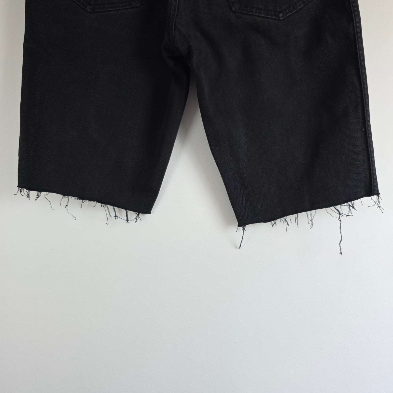 Wrangler black denim shorts W33 with frayed hems and copper-toned button.