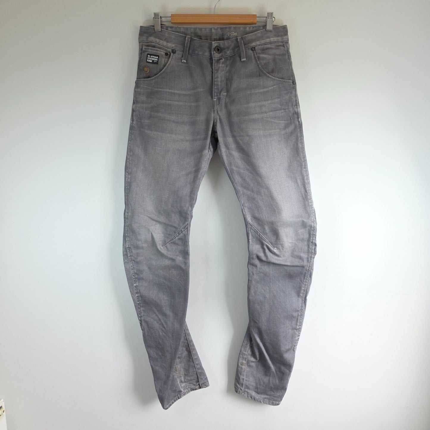 G-Star grey straight jeans with biker style detailing and subtle wear at the hem.