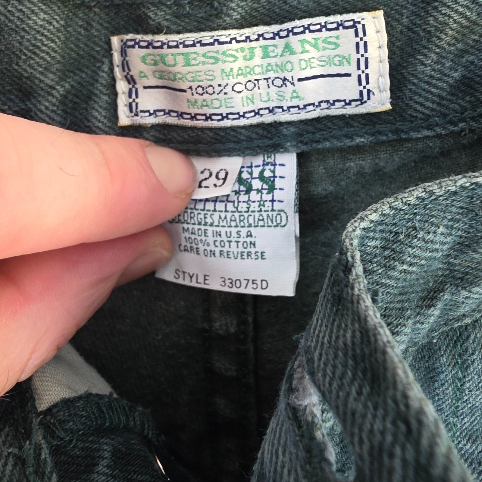 Levi's 501 white jeans distressed with natural wear, made in USA, classic fit.