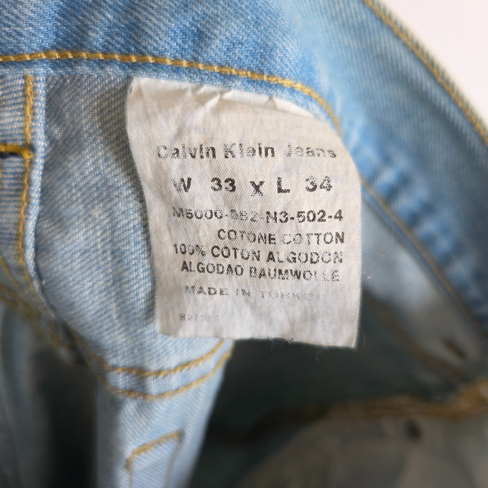 Calvin Klein light blue straight jeans, 100% cotton, classic five-pocket design.