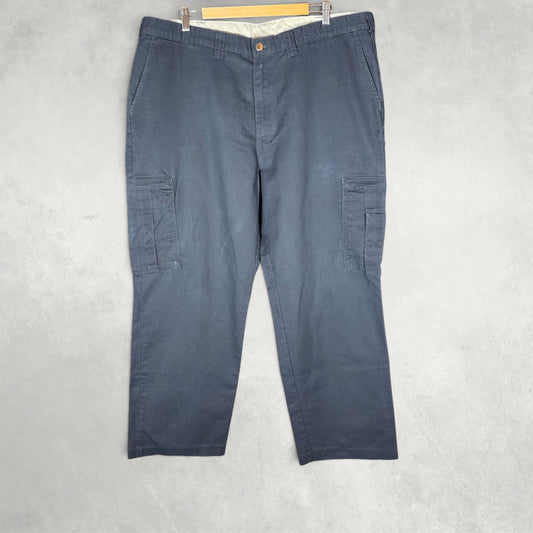 Dickies blue cargo trousers with zipped pockets and relaxed fit, made from durable flex fabric.
