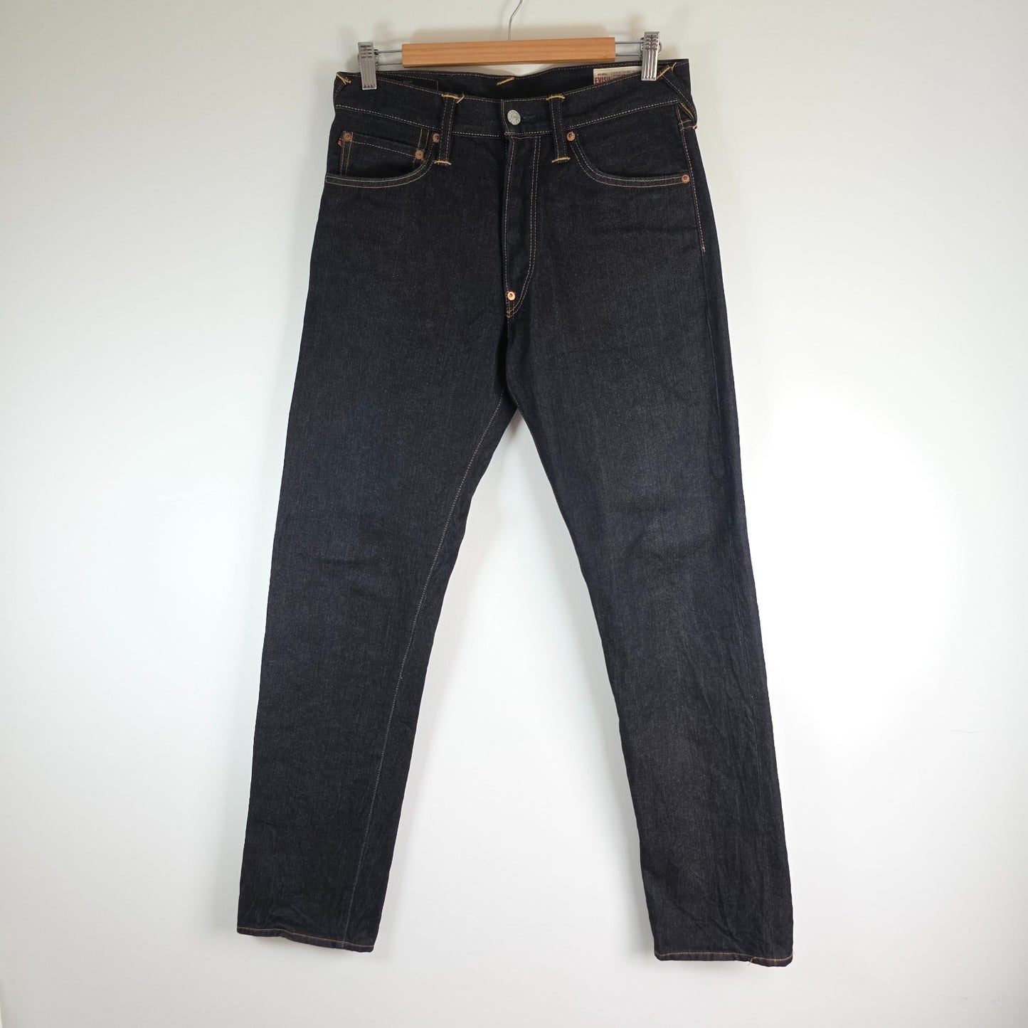 Evisu blue straight jeans with selvedge denim and button fly detailing.