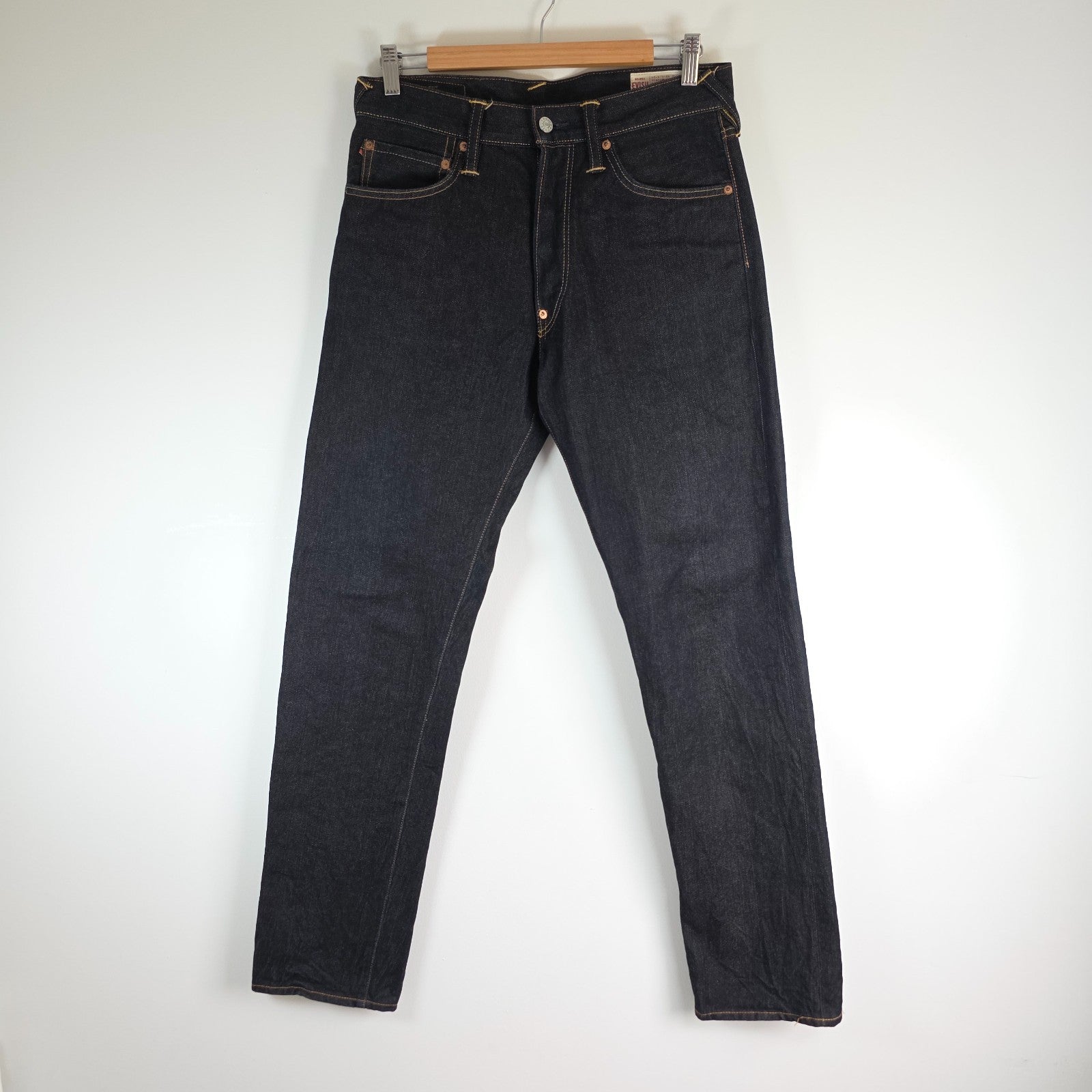 Evisu blue straight jeans with selvedge denim and button fly detailing.